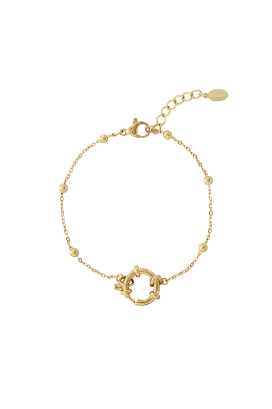 Gold-toned minimalist beaded bracelet with circular toggle clasp and small polished beads on a white background