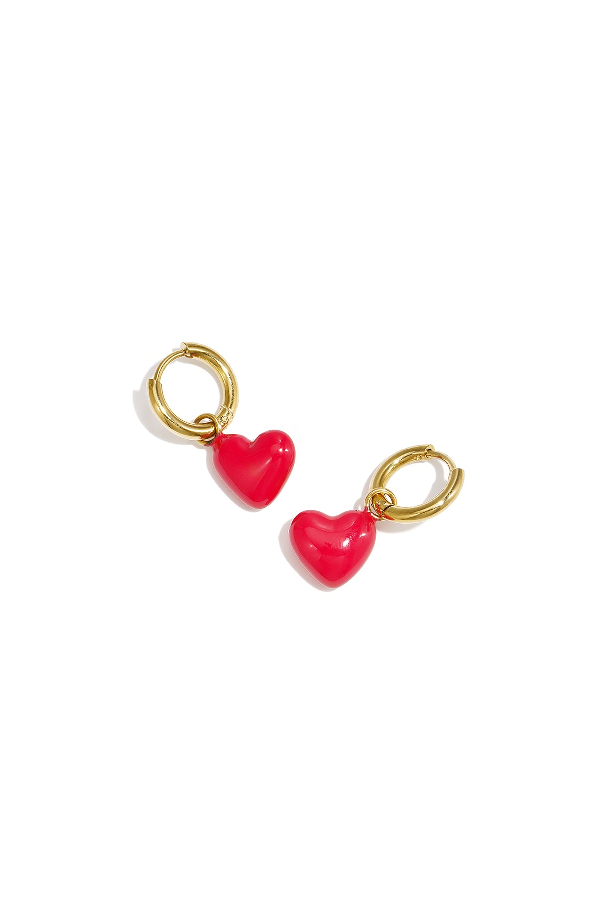 Gold-tone hoop earrings with red glossy heart enamel charms on white background