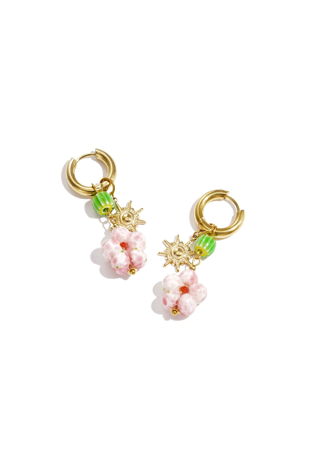 Gold hoop earrings with pink beaded flower, green bead, and sun charm on white background