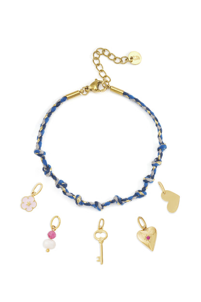 Cotton braided chain bracelet with gold lobster clasp and assorted gold charms including heart, flower, key, and beads on white background.