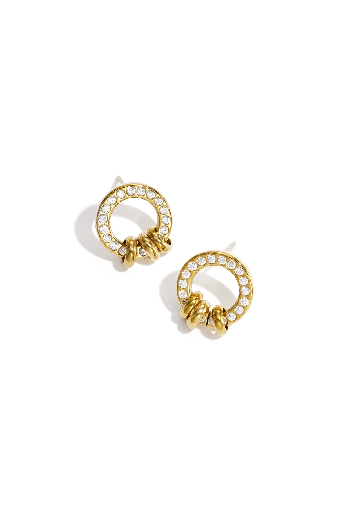 Gold tone circle stud earrings adorned with clear crystals and three small gold loops at the base on white background