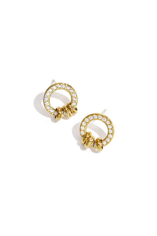 Gold tone circle stud earrings adorned with clear crystals and three small gold loops at the base on white background