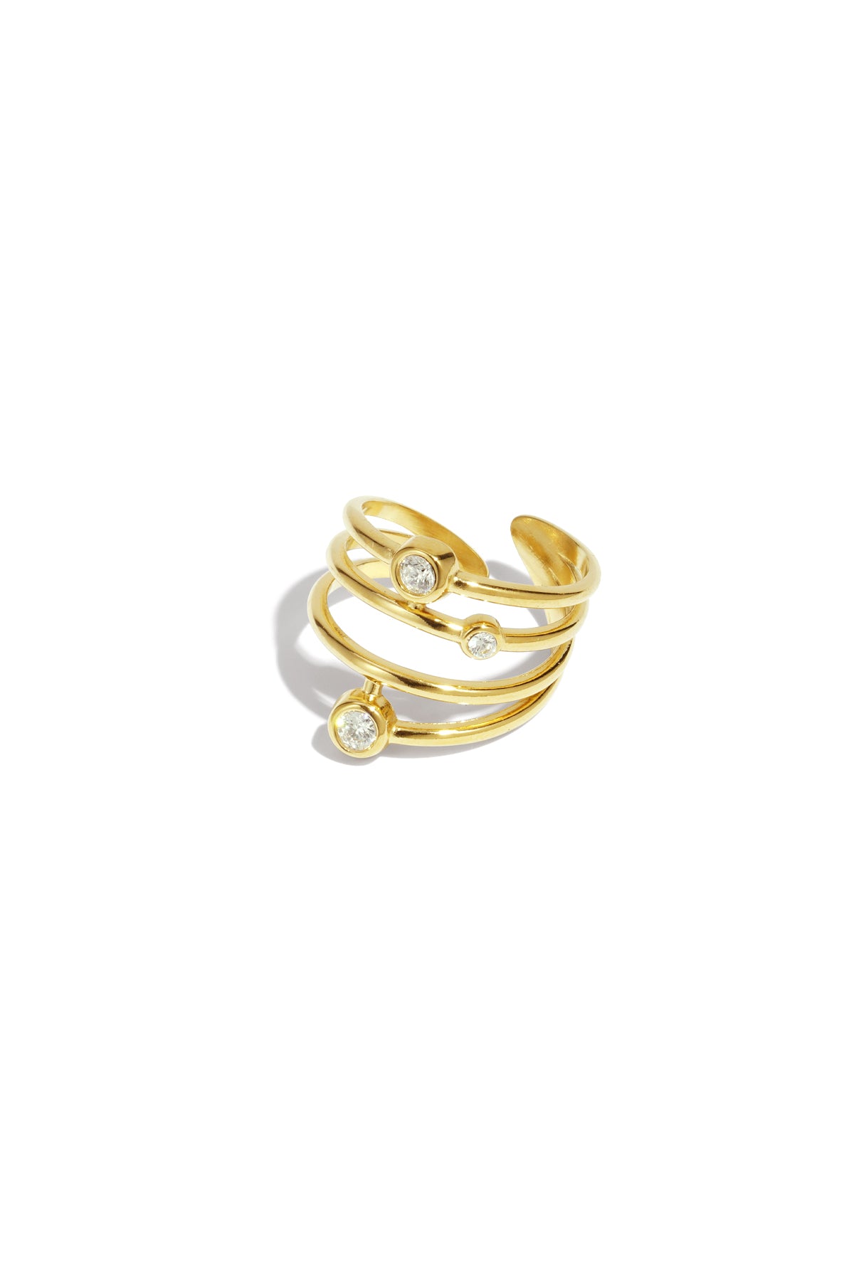 Gold tone multi-band adjustable statement ring with three bezel set rhinestones on white background