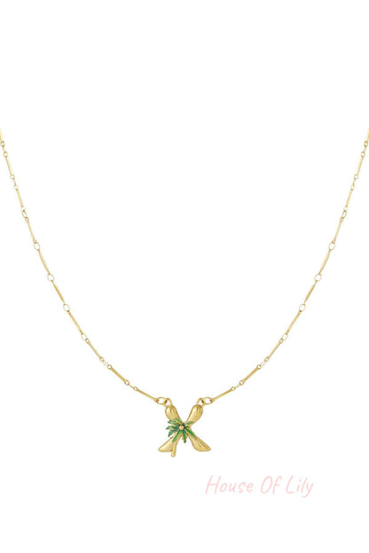 Gold chain necklace with a letter 'X' pendant featuring a green palm tree design at the center.