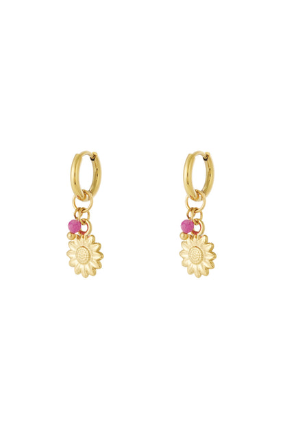 Pair of gold hoop earrings with sunflower charm and small pink bead accents displayed on white background