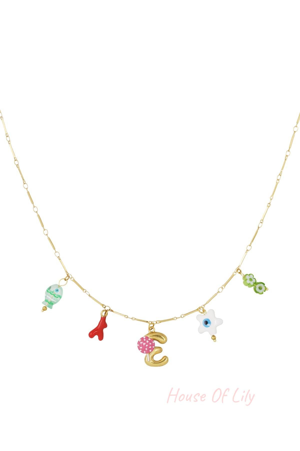 Gold charm necklace with yellow lemon, blue strawberry, white fish, and gold letter G charms