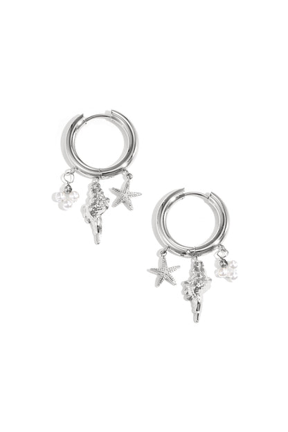 Silver-plated hoop earrings with dangling starfish, seashell, and pearl charms on white background