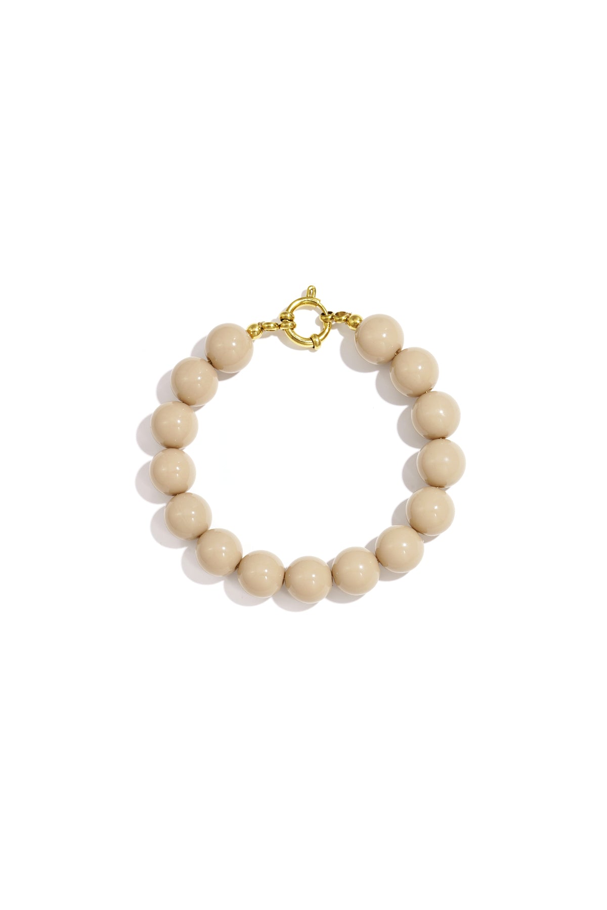 Beige resin bead bracelet featuring round, glossy beads and a central gold-tone circular clasp on a white background.