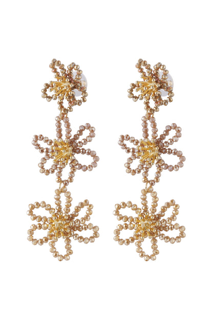 Front view of light brown floral beaded dangle earrings with gold tone centers
