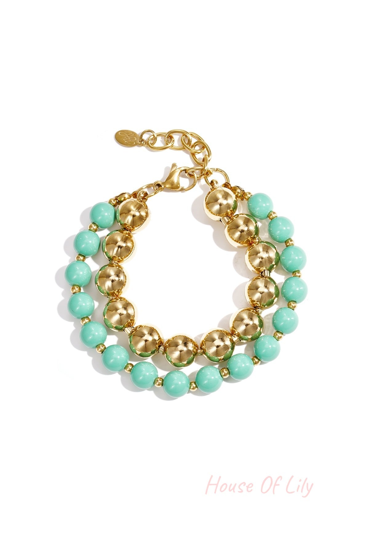Double layered bracelet with mint green acrylic and gold-tone beads on white background