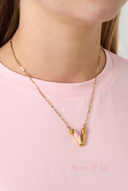 Gold chain necklace with gold seashell, red crescent moon, blue flower charms, white pearl, blue fish charm, and gold letter B with pink flower pendant