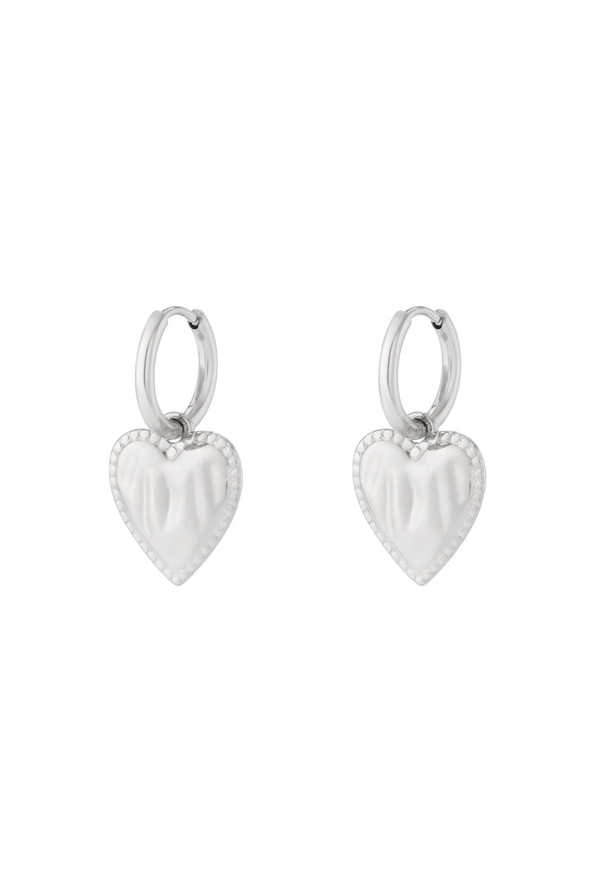 Silver heart charm hoop earrings with beaded edge detail isolated on white background