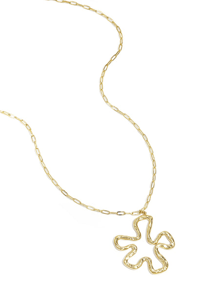 Gold link chain necklace with a wavy, abstract flower-shaped pendant lying flat on white background
