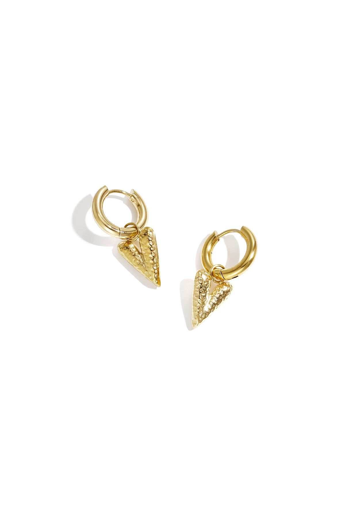 Pair of gold hoop earrings with textured heart-shaped pendants displayed on white background