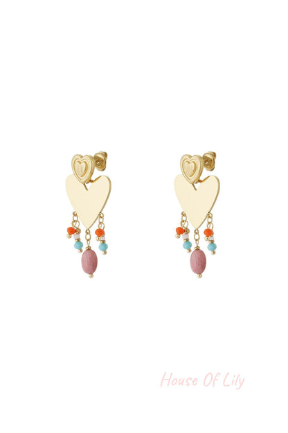 Pair of gold-tone heart drop earrings with colorful pink, orange, and light blue bead charms dangling below a textured smaller heart stud on white background.