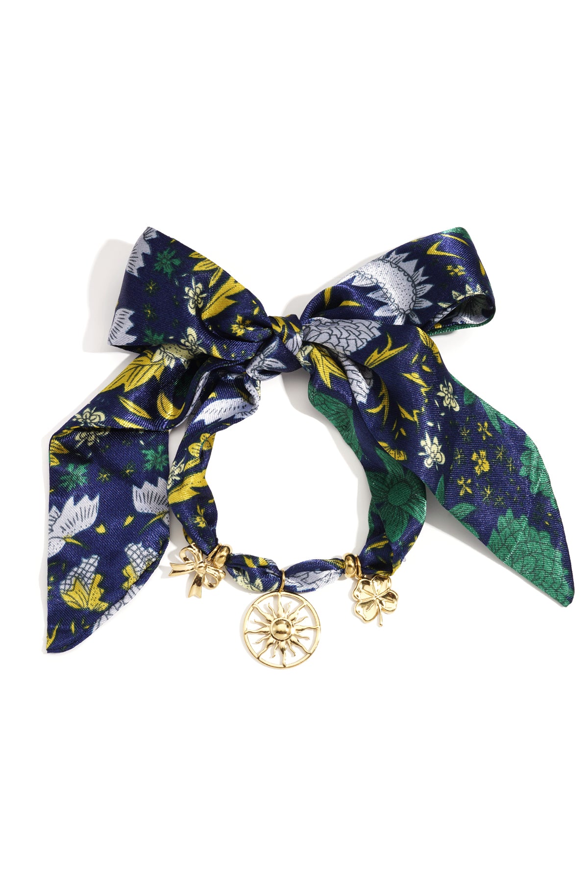 Floral patterned fabric bracelet tied in a bow with gold-tone sun, bow, and clover charms