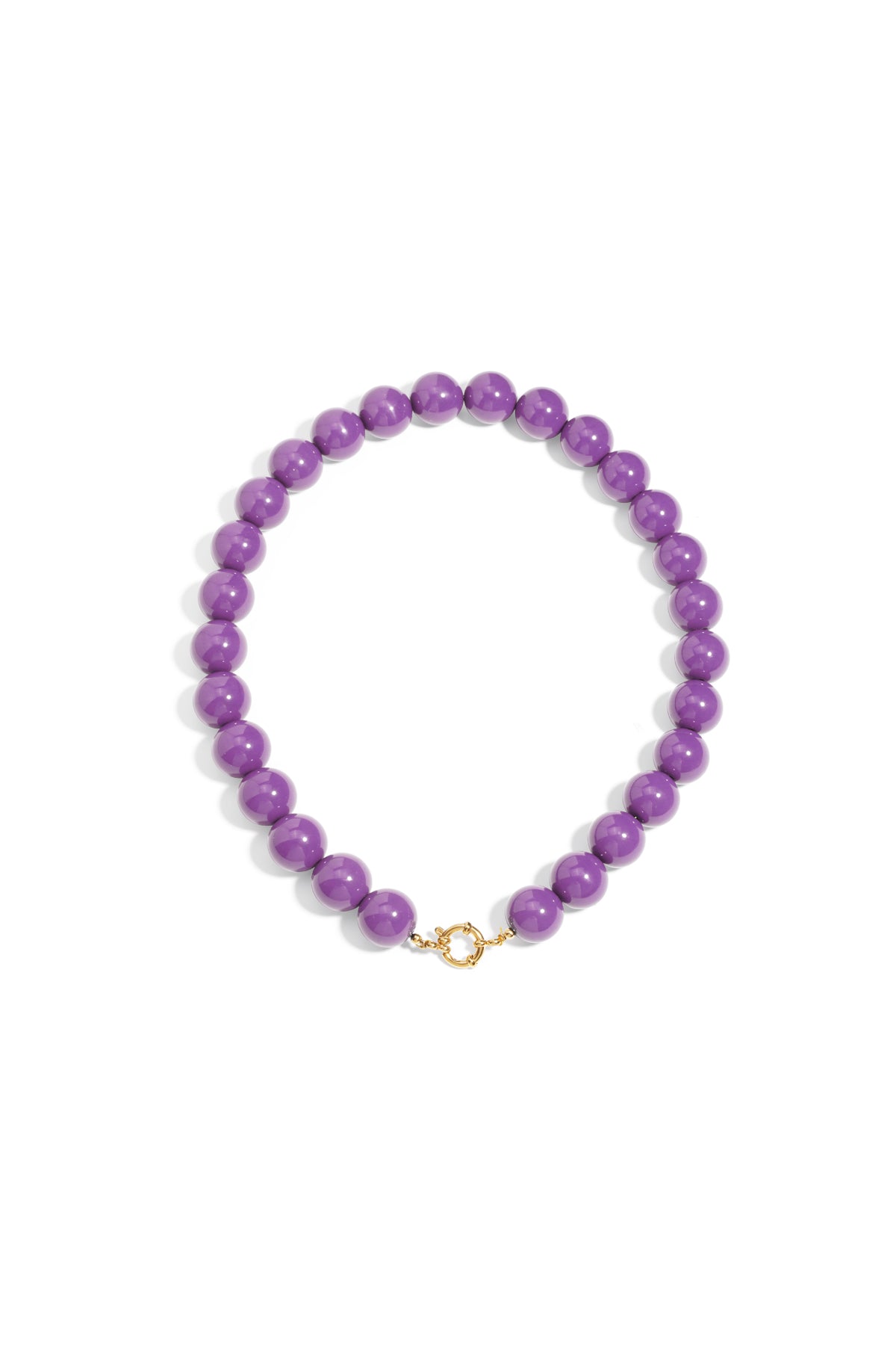 Chunky purple resin bead necklace featuring a gold-toned circular front clasp on a plain white background.