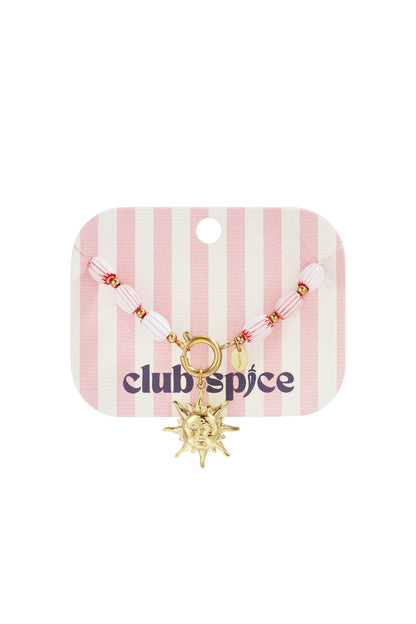 Pink and white striped beaded bracelet with gold-tone sun charm on striped pink and white card with Club Spice logo
