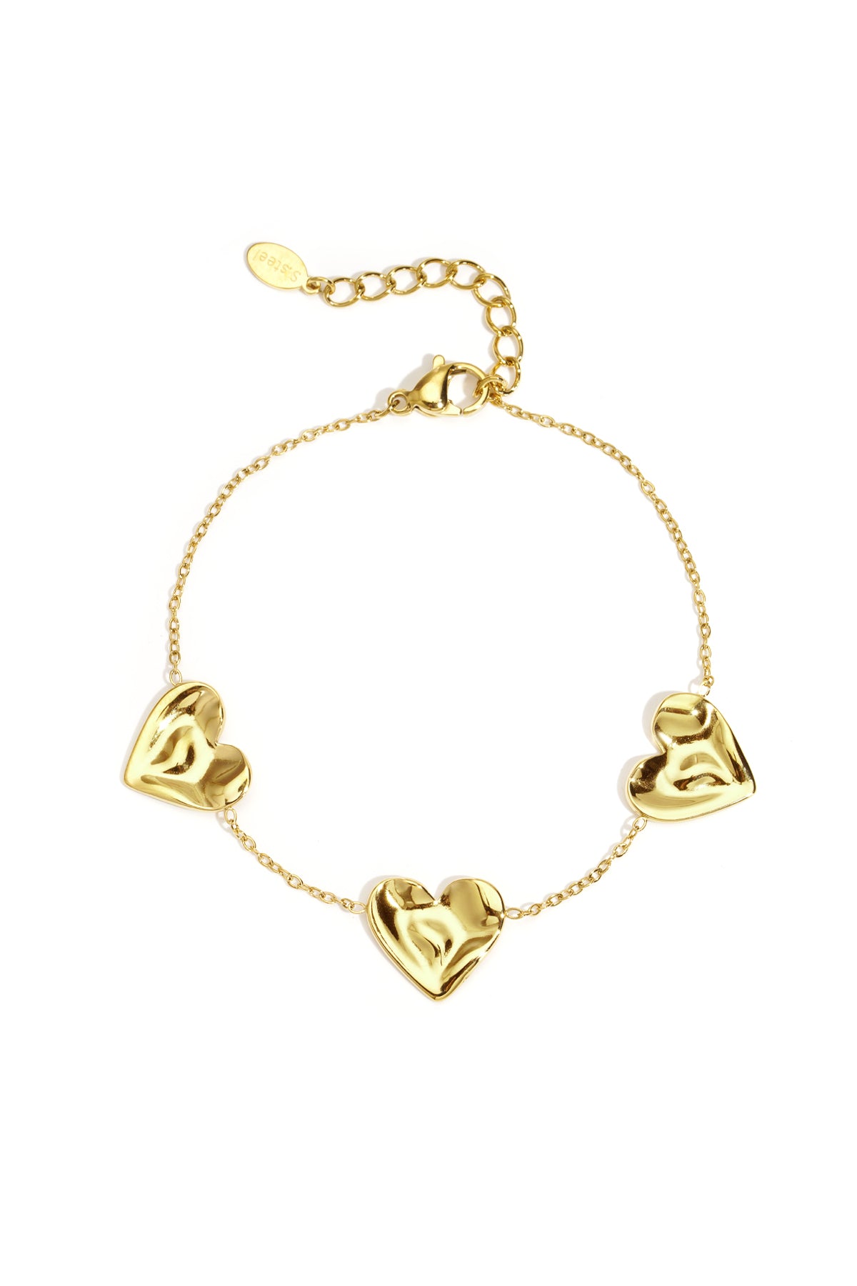 Gold tone charm bracelet with three sculpted heart-shaped charms linked by delicate chain on white background