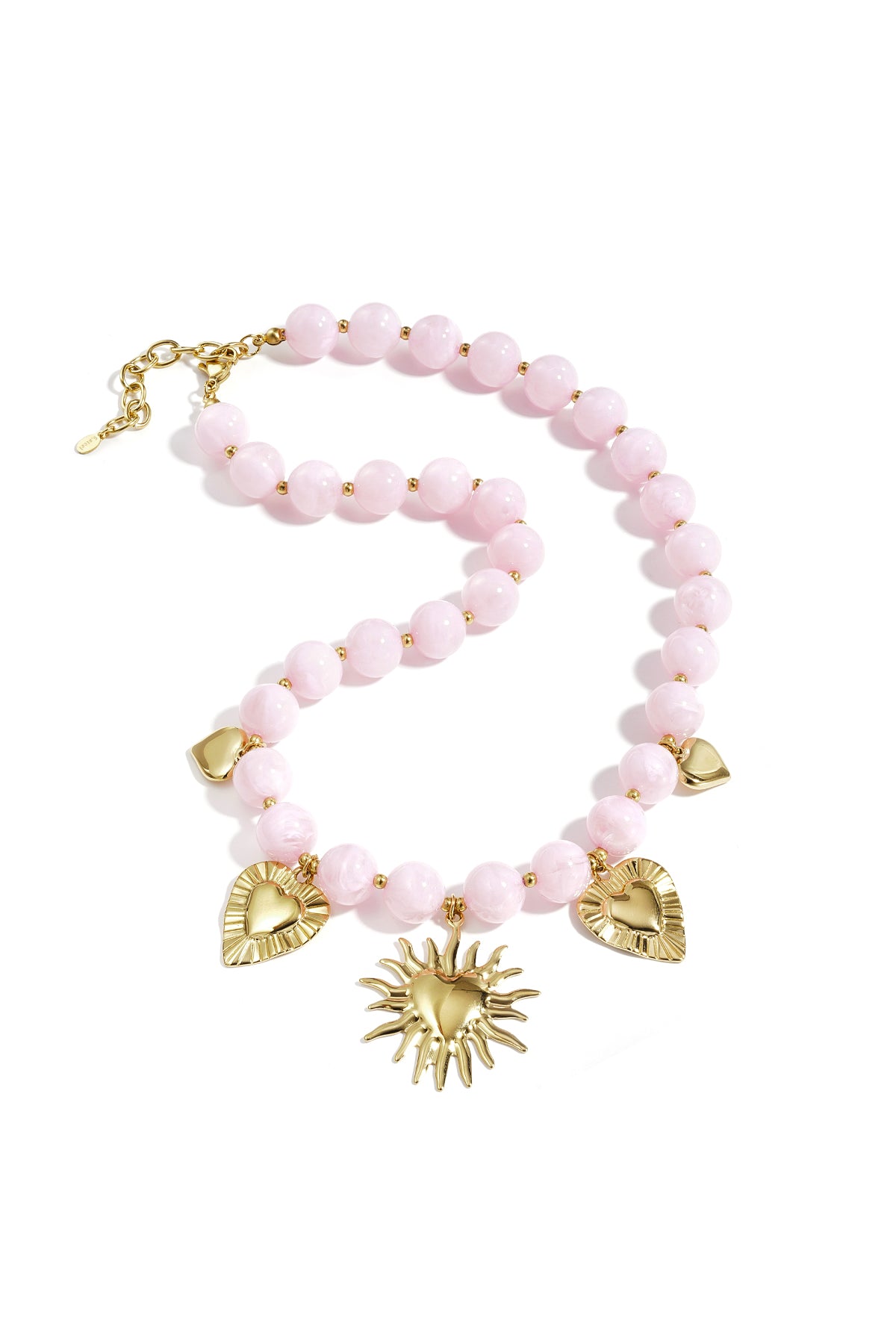 Soft pastel pink beaded necklace with gold heart and sun charms displayed on white background
