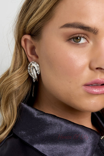Model wearing gold-toned twisted chain stud earring close-up showing earrings and side of face