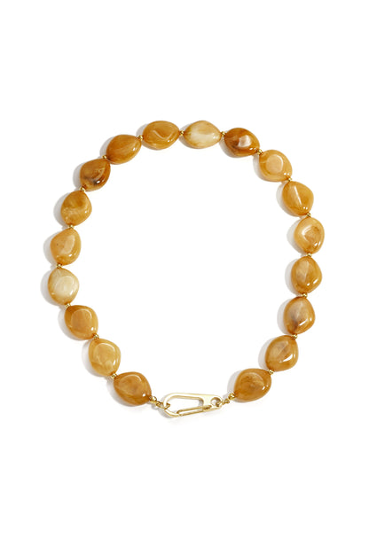 Amber colored chunky resin beaded necklace with gold-tone front clasp and irregular oval beads arranged in a circle