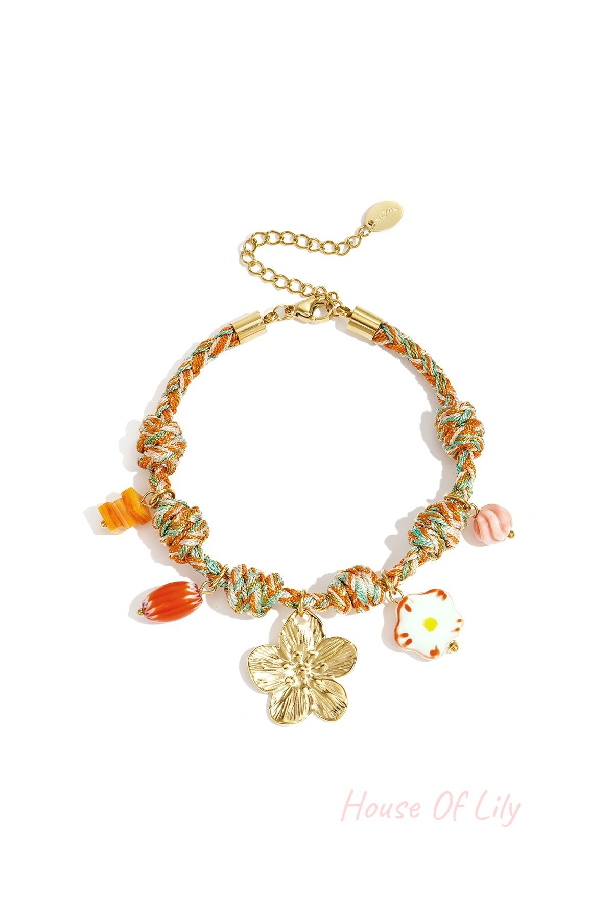 Orange and teal twisted rope charm bracelet with gold flower pendant and colorful glass charms against white background
