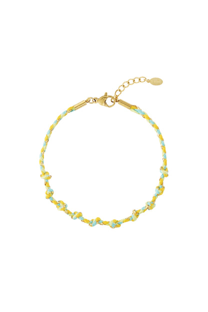 Red and beige braided cotton chain bracelet entwined with gold thread and lobster clasp on white background.