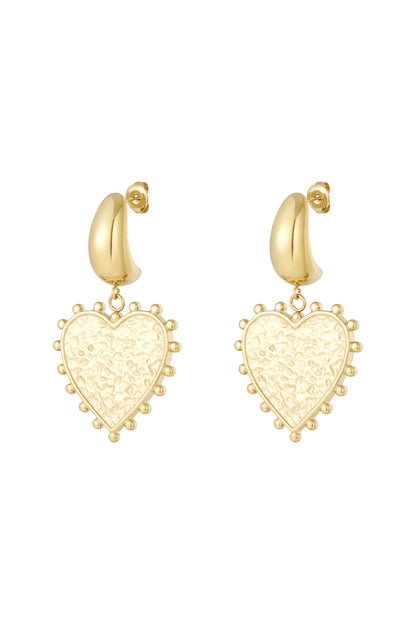 Pair of gold modern heart-shaped drop earrings with textured centers and dotted edges on white background