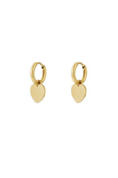 Gold hoop earrings with smooth heart-shaped drop charms on white background
