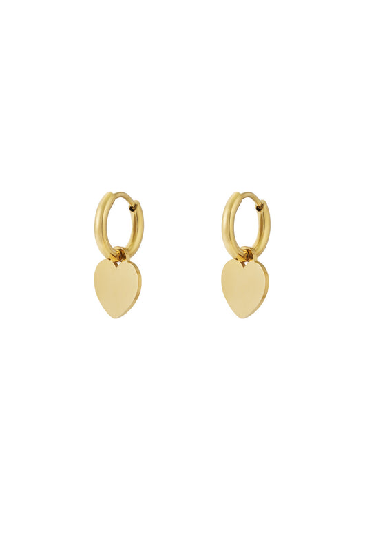 Gold hoop earrings with smooth heart-shaped drop charms on white background