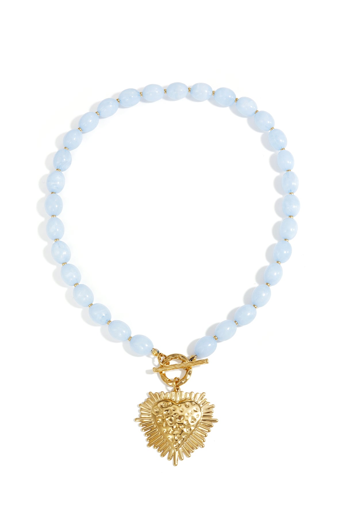 Necklace with light blue oval beads, gold toggle clasp, and a textured, sunburst-style gold heart pendant.