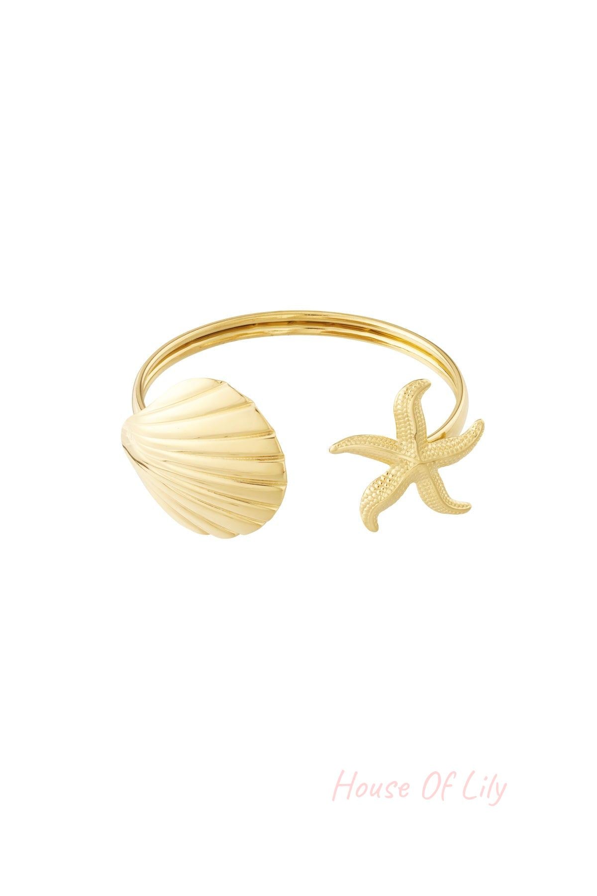 Gold open cuff bangle bracelet featuring a polished shell design on one end and a textured starfish design on the other, isolated on white background