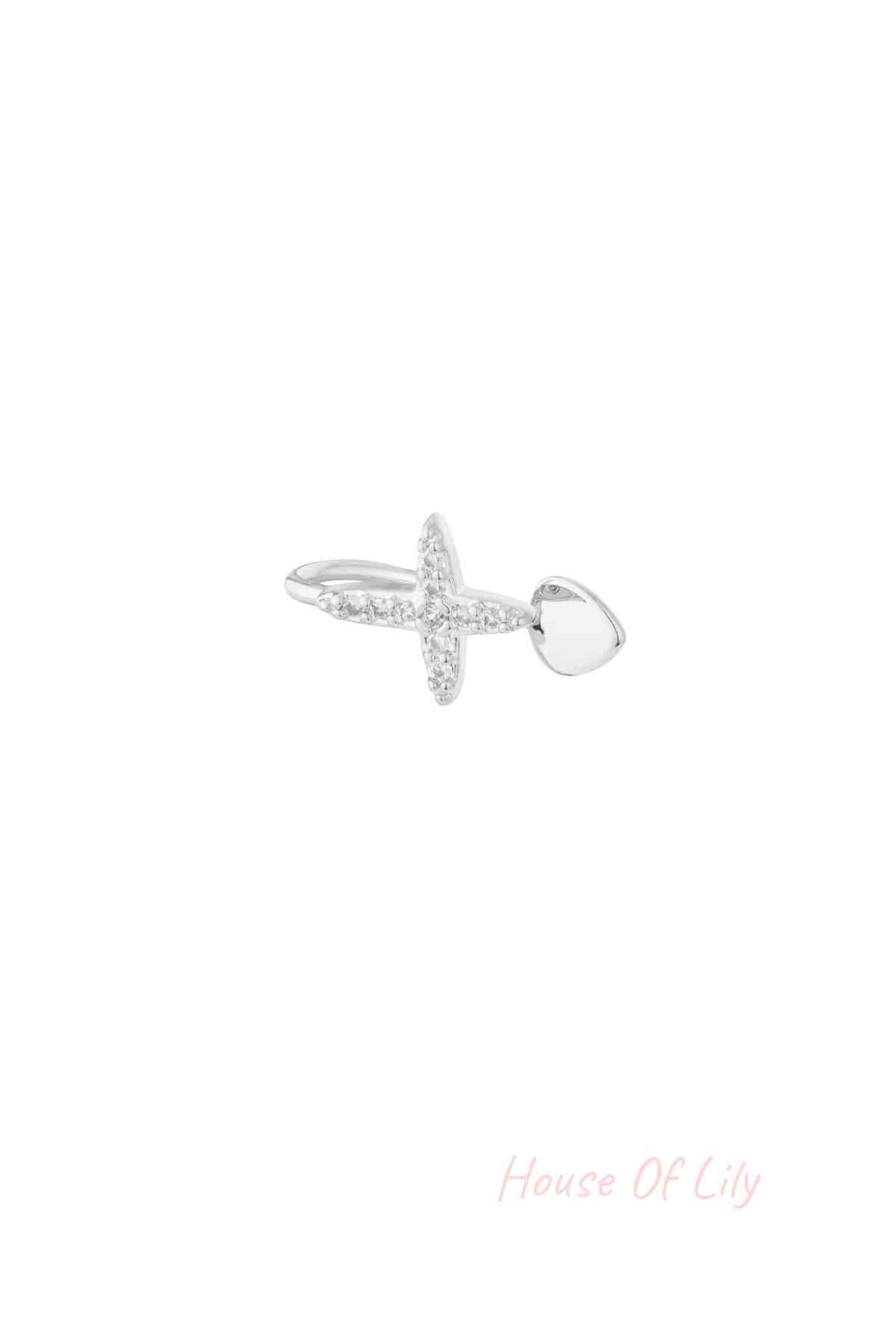 Silver version of the cross-shaped nose and ear cuff adorned with clear cubic zirconia stones shown on white background