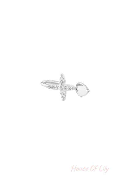 Silver version of the cross-shaped nose and ear cuff adorned with clear cubic zirconia stones shown on white background
