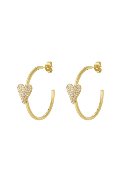 Pair of gold hoop earrings with rhinestone-studded heart accents on white background