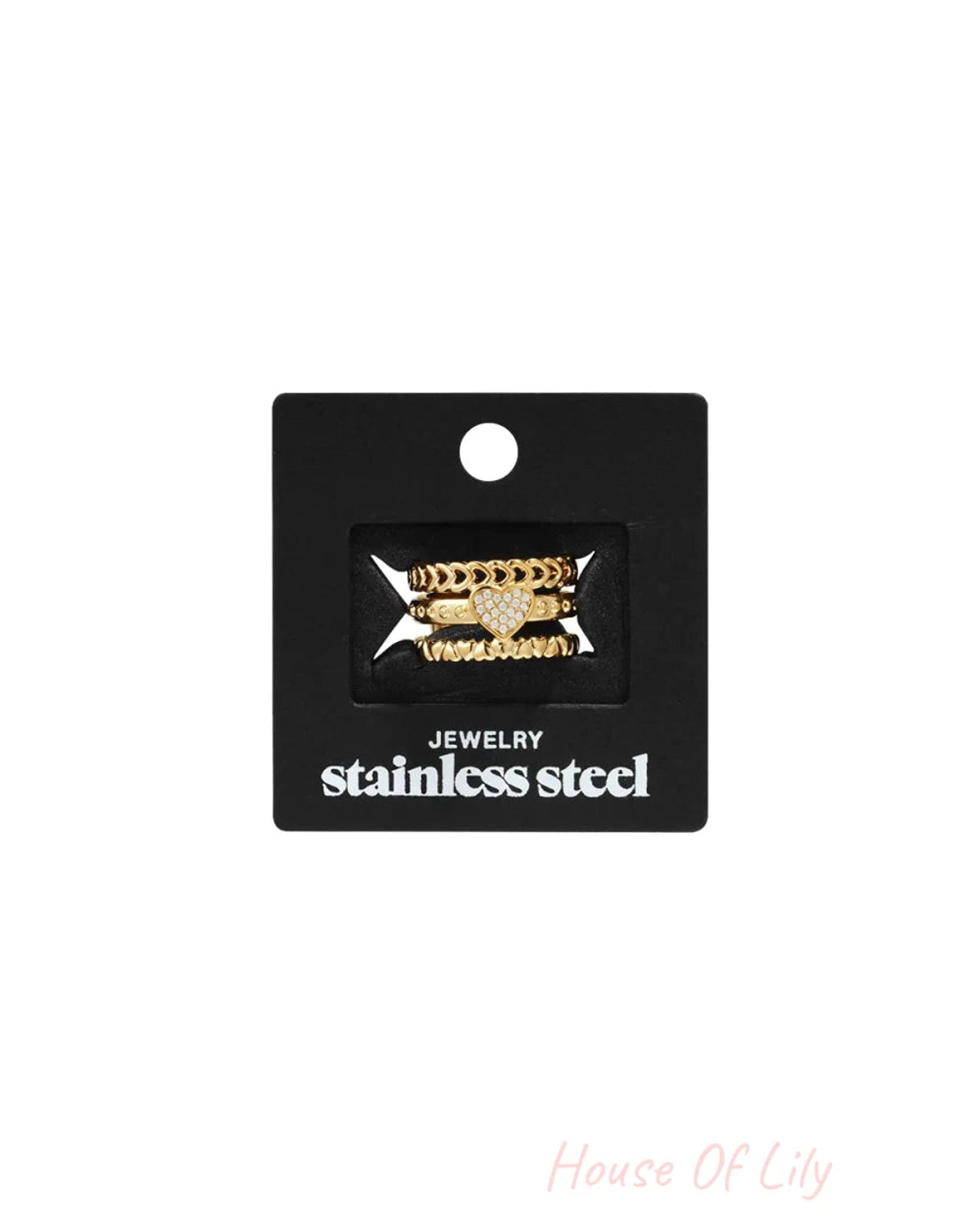 A set of three gold-colored stainless steel rings on a black card.