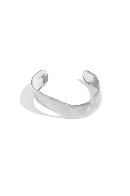 Silver curved minimalist cuff bracelet with brushed texture finish on a white background