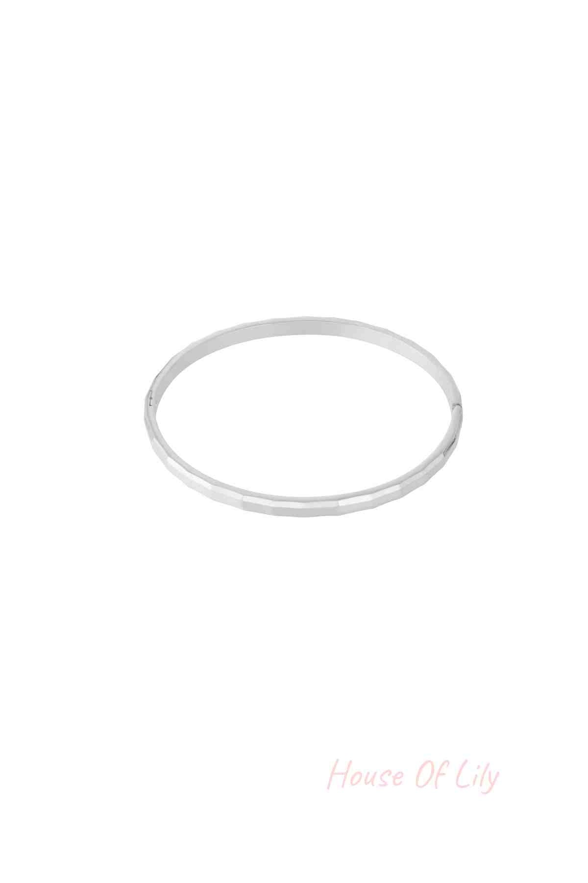 Single geometric faceted silver bangle isolated on white background