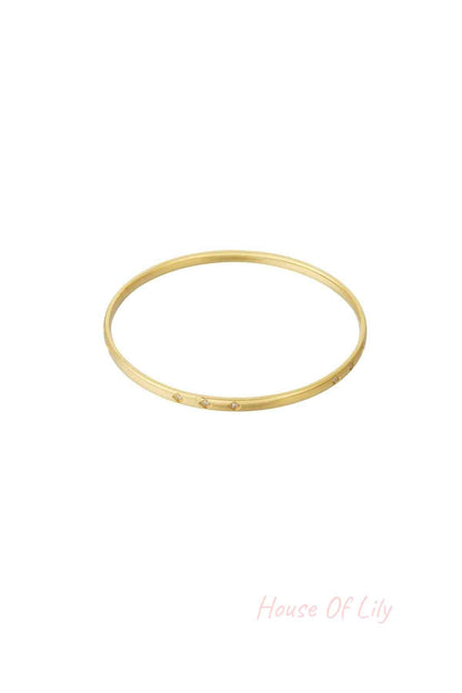 Gold mini diamond bangle with small rhinestone accents displayed on white background