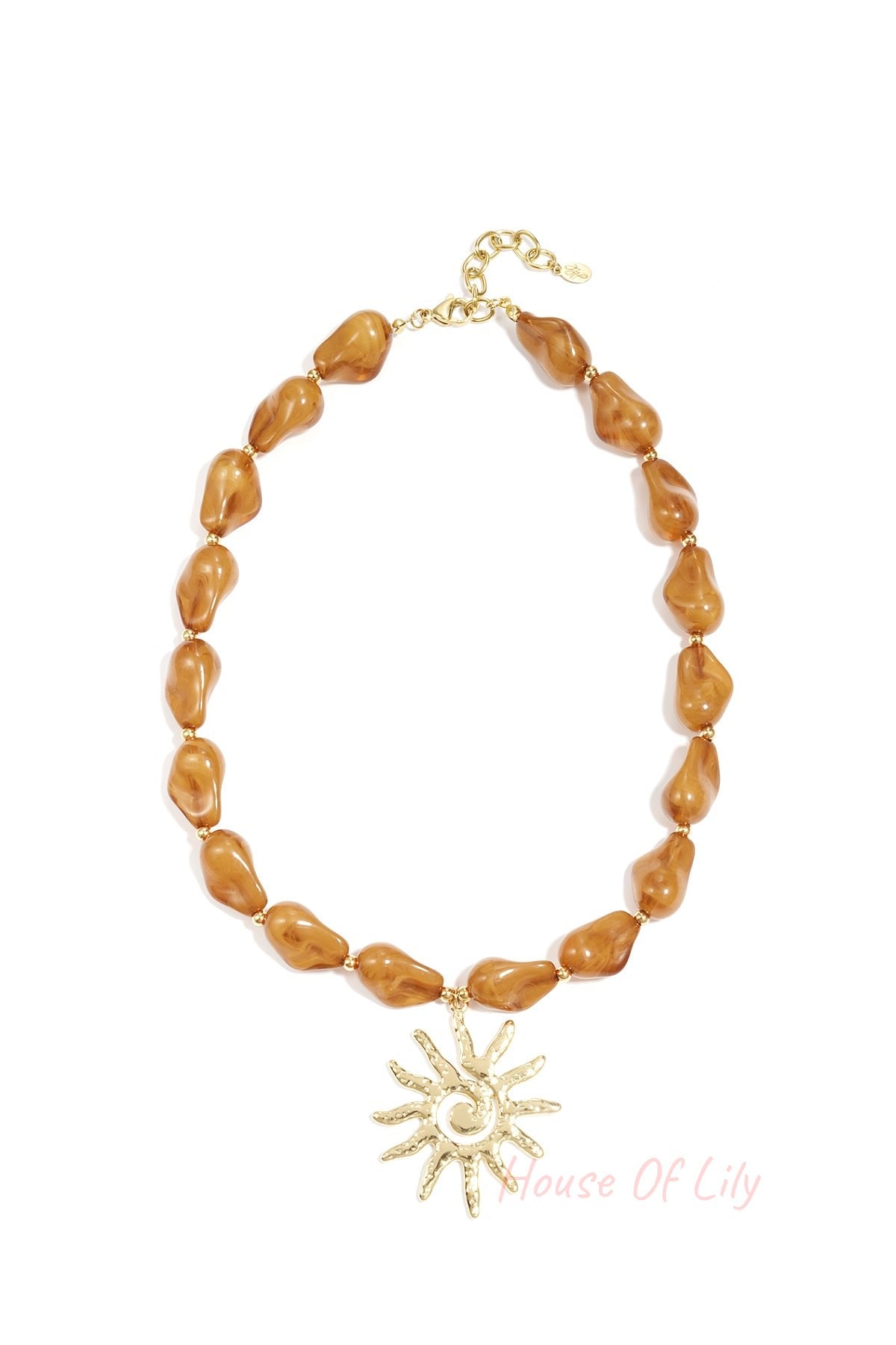 Close-up image of a caramel brown acrylic beaded necklace featuring an artistic gold sun pendant on a white background