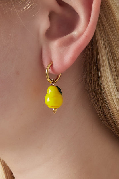 Close up of a woman's ear wearing a gold hoop earring with a dangling yellow pear-shaped enamel charm
