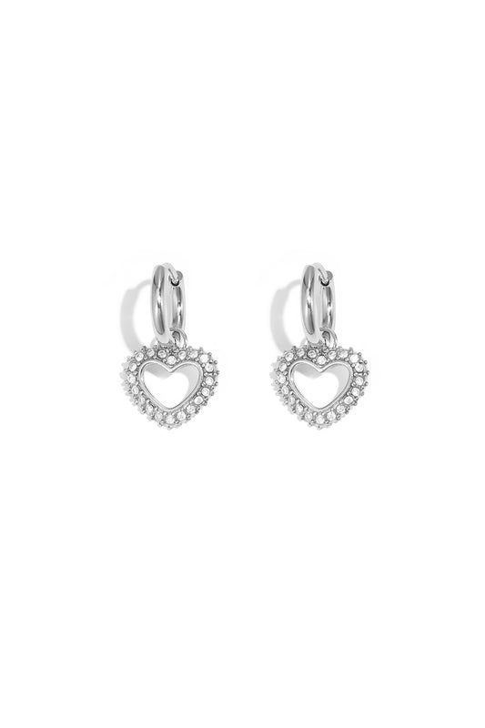 Silver-tone heart-shaped rhinestone drop earrings with smooth hoop closure on white background