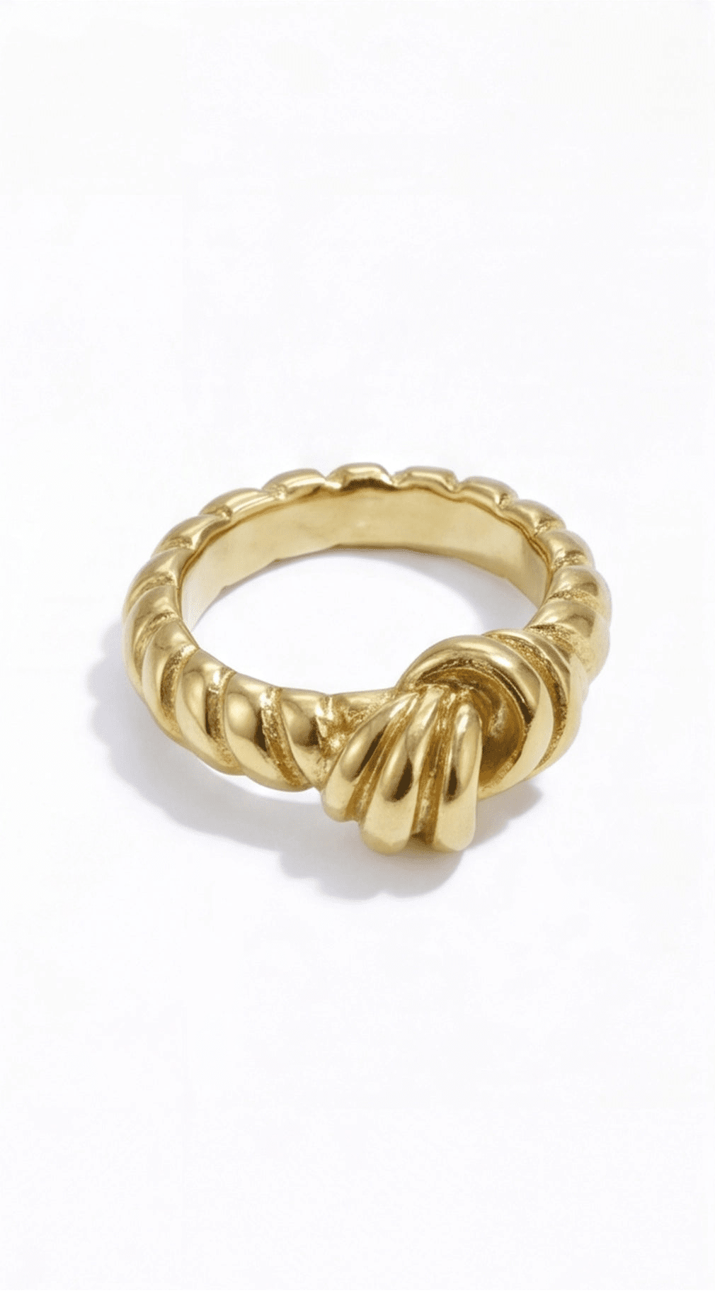 Gold ring with a textured design on a white background