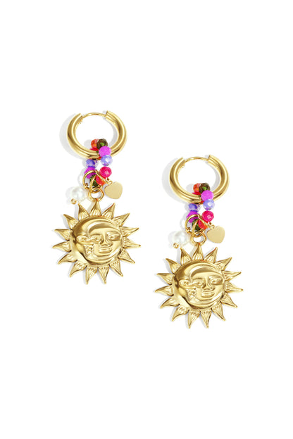 Pair of golden drop earrings featuring sun face charms, vibrant colorful beads, small pearl, and tiny gold heart charms