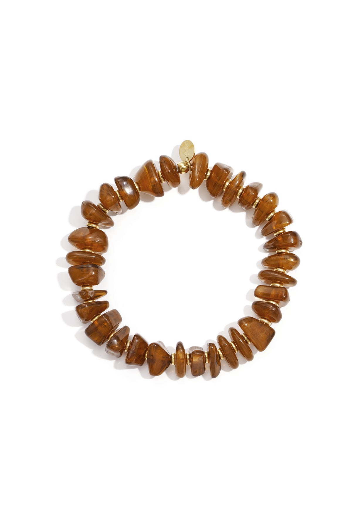 Warm amber colored chunky beaded stretch bracelet with gold-tone spacers on white backdrop