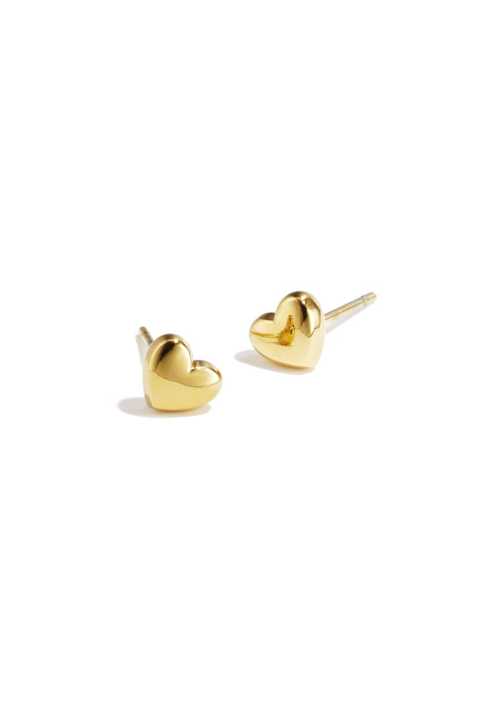 Pair of polished gold heart-shaped stud earrings on white background