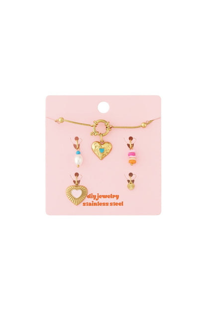 Elegant gold-tone stainless steel heart link bracelet set with colorful charms on a pink display card.