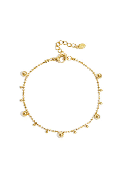 Gold-toned delicate beaded chain bracelet with alternating small and medium shiny balls and adjustable lobster clasp