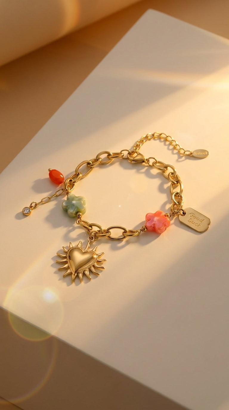 Charm Era Unlocked gold link bracelet with sun-heart pendant, colorful flower charms, and a "Good Luck" tag.